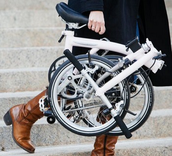 Walking down steps holding a folded Brompton bicycle