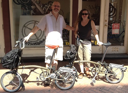 2 customers leaving our bike shop with their new Brompton folding bikes