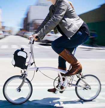 Riding a Brompton bike fitted with a removeable, purse sized bag