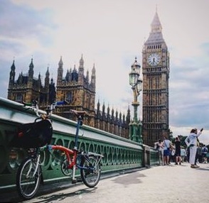 2 customers leaving our bike shop with their new Brompton folding bikes